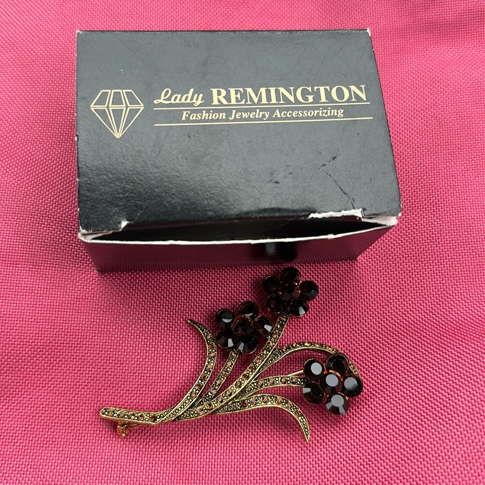Vintage Lady Remington floral brooch with topaz rhinestones.